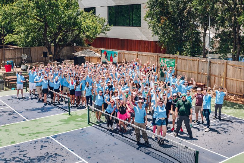 Iodine Software's team cheers on a tennis court