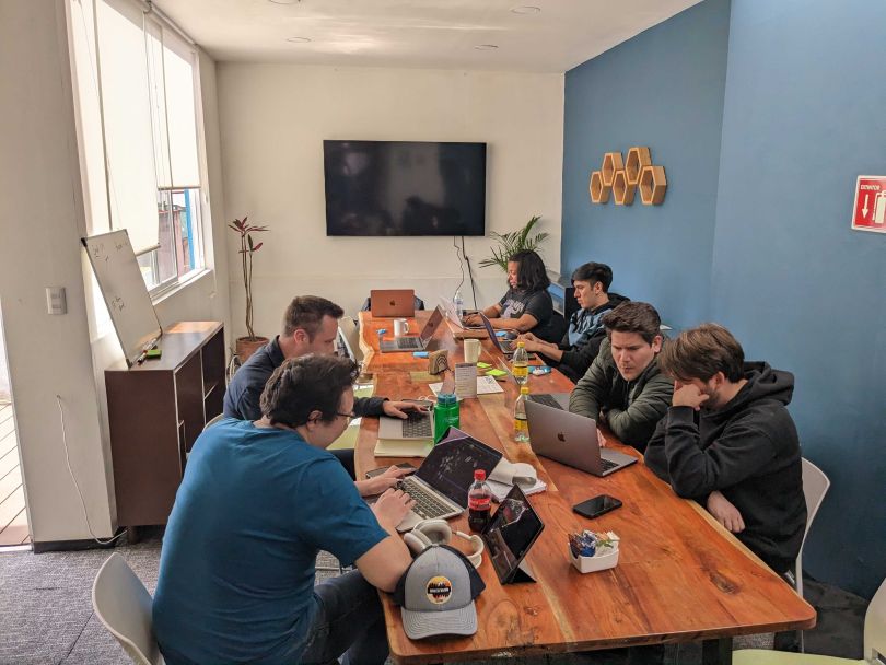 Employees of Routefusion work on laptops in the company's office