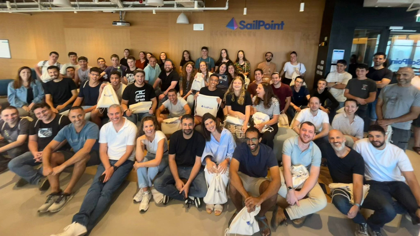 SailPoint-employees-seated-in-a-large-group-in-front-of-a-branded-office-wall.%20%20-%20Edited_0.jpg
