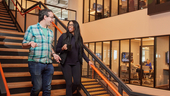 coworkers walking down stairs chatting